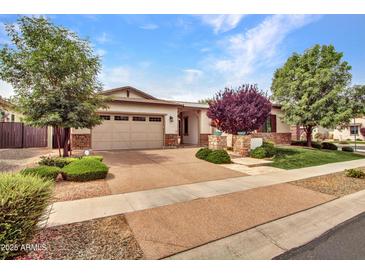 Charming single-story home featuring a stone accent facade, attached garage, and manicured landscaping at 3809 E Lynx Pl, Chandler, AZ 85249