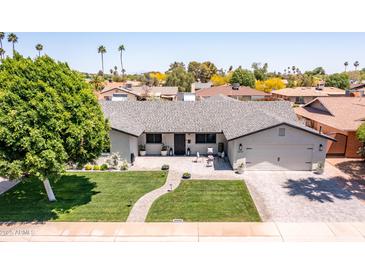 Beautiful home featuring a well manicured yard, updated roof, and brick driveway and walkway at 5919 S Newberry Rd, Tempe, AZ 85283
