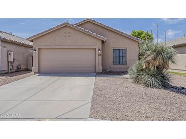 Charming home featuring a two-car garage and a xeriscaped front yard at 8733 W Laurel Ln, Peoria, AZ 85345