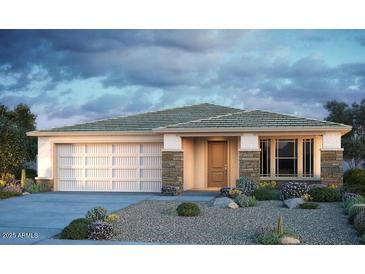 Charming single-story home showcasing stone accents, a two-car garage, and desert landscaping at 10909 S 52Nd Dr, Laveen, AZ 85339