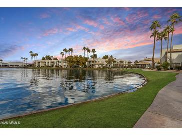 Scenic lakeside community featuring lush landscaping and palm trees against a vibrant sunset backdrop at 1825 W Ray Rd # 2132, Chandler, AZ 85224