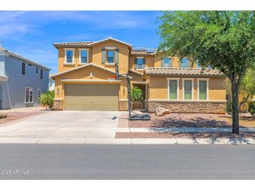 Two-story home featuring a two-car garage, well-maintained landscaping, and a basketball hoop in the driveway at 3436 E Gary Way, Gilbert, AZ 85234