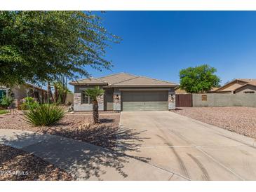 Charming single-story home with desert landscaping, neutral colors, and a two-car garage, offering curb appeal at 4100 S Dewdrop Ct, Gilbert, AZ 85297