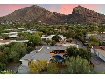 Stunning aerial view of a modern home with a pool and mountain views at 6417 N 52Nd Pl, Paradise Valley, AZ 85253