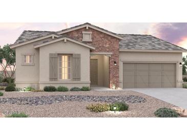 Charming single-story home featuring stone accents, neutral color palette, and a well-manicured desert landscape at 8746 S 168Th Ave, Goodyear, AZ 85338