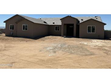 Newly built single Gathering home with a neutral color scheme and simple landscaping awaiting customization at 9485 W Sandstone Mountain Dr, Casa Grande, AZ 85194
