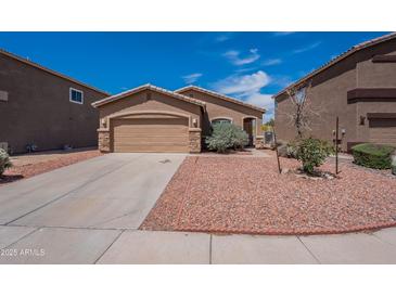 Charming single-story home features a two-car garage and desert landscaping for easy maintenance at 14244 N 132Nd Ln, Surprise, AZ 85379