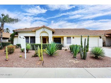 Charming single-story home featuring desert landscaping with cacti and a tile roof under a partly cloudy sky at 14605 S 35 Pl, Phoenix, AZ 85044