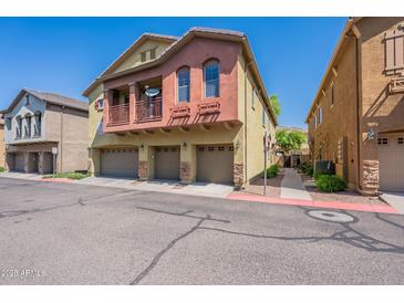 Charming two-story townhouse with three-car garage and private balcony on a sunny day at 18250 N 32Nd St # 1019, Phoenix, AZ 85032