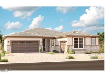 Charming single-story home with stone accents, well-manicured desert landscaping and a two-car garage at 20274 W Monterey Way, Buckeye, AZ 85396