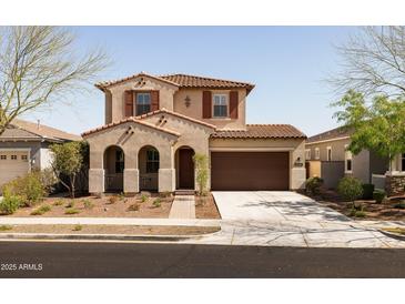 Charming two-story home featuring a tile roof, covered porch, and a two-car garage, perfect for Gathering living at 20473 W Legend Trl, Buckeye, AZ 85396