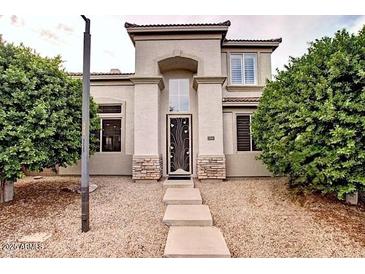 Charming two-story home with neutral tones, arched entry, and manicured landscaping at 2308 S Bernard --, Mesa, AZ 85209