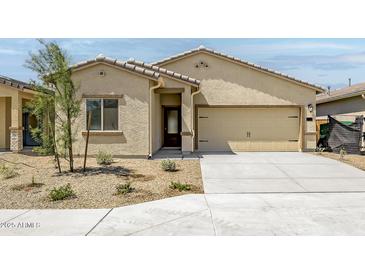 Charming single-story home featuring a two-car garage and low maintenance desert landscaping at 24571 W St Anne Ave, Buckeye, AZ 85326