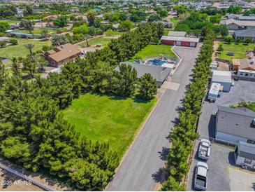 Expansive property featuring a sparkling pool, lush greenery, and ample parking at 25829 S Mandarin Dr, Queen Creek, AZ 85142