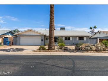 Charming single-story home featuring a well-maintained yard and attached garage at 100 E Geneva Dr, Tempe, AZ 85282