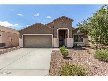 Charming single-story home featuring a two-car garage and low-maintenance desert landscaping at 12041 W Melinda Ln, Sun City, AZ 85373