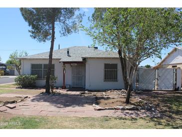 Charming single-story home with a well-maintained yard and classic architectural details at 1367 E Clarendon Ave, Phoenix, AZ 85014