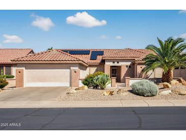 Charming single-story home featuring a tile roof, desert landscaping, and a two-car garage in a sunny neighborhood at 20394 N Coronado Way, Surprise, AZ 85374