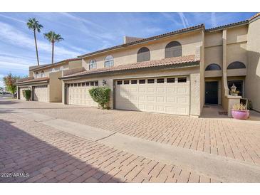 Charming townhouse with a two-car garage and well-maintained brick driveway at 2142 E Turney Ave # 9, Phoenix, AZ 85016