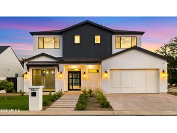Stunning two-story modern home with a well-manicured lawn and a symmetrical design at 4911 E Amelia Ave, Phoenix, AZ 85018