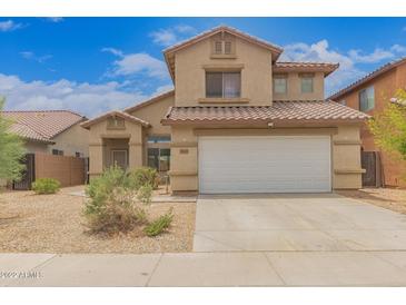 Charming two-story home with a well-maintained front yard, a two-car garage and a tile roof at 5123 W Novak Way, Laveen, AZ 85339