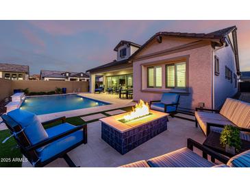 Inviting backyard with a pool, fire pit, and comfortable seating area for outdoor relaxation at 8138 E Jacaranda St, Mesa, AZ 85207