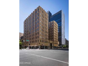 Tan brick building exterior on a corner, showing 1st Avenue sign on a clear sunny day in Phoenix, AZ at 114 W Adams St # 907, Phoenix, AZ 85003