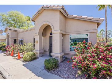 Charming single-story home featuring an arched entryway and well-maintained landscaping at 14300 W Bell Rd # 261, Surprise, AZ 85374