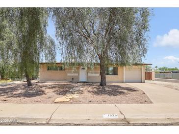 Charming single-story home with mature trees offering shade and curb appeal at 1526 W Huntington Dr, Tempe, AZ 85282