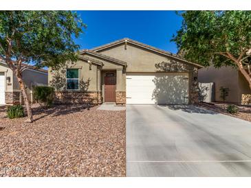 Charming single-story home with a well-maintained front yard and attached two-car garage at 36203 N Urika Dr, San Tan Valley, AZ 85140