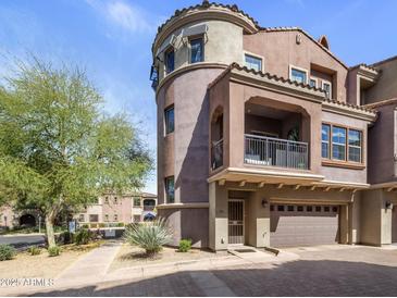 Elegant Mediterranean-style townhome featuring a private balcony and a two-car garage at 3935 E Rough Rider Rd # 1252, Phoenix, AZ 85050