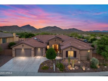 Stunning exterior of the home with well manicured landscaping and a three car garage at 42037 N Bradon Way, Phoenix, AZ 85086