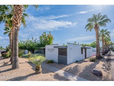 Well-maintained condo exterior showcasing modern design, landscaping, and desert plants at 4206 N 38Th St # 1, Phoenix, AZ 85018