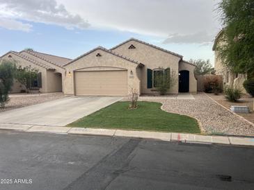 Charming single-story home featuring a well-maintained front yard and attached two-car garage at 43845 W Elizabeth Ave, Maricopa, AZ 85138