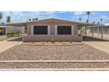 Charming single-story home with desert landscaping and covered parking at 1654 S 77Th St, Mesa, AZ 85209