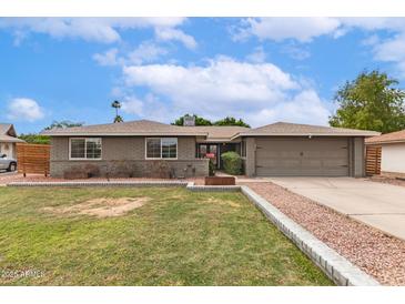 Charming single-story home with a well-manicured lawn and a neutral color palette at 5926 S Newberry Rd, Tempe, AZ 85283