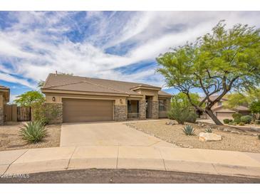 Charming single-story home with desert landscaping, stone accents, and a two-car garage at 10623 E Acacia Dr, Scottsdale, AZ 85255
