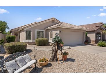 Charming single-story home featuring a desert-landscaped yard, bench, and neutral-tone exterior at 1241 E Elm Rd, San Tan Valley, AZ 85140