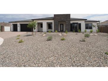 Single story home featuring a low maintenance front yard, attached garage, and neutral color palette at 3824 W Lodge Dr, Laveen, AZ 85339
