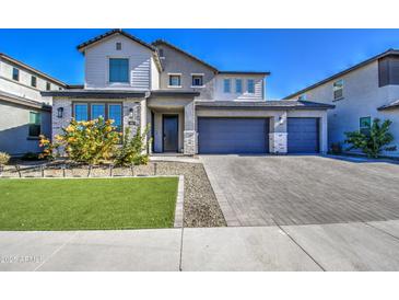 Charming two-story home with a three car garage, manicured lawn, and desert landscaping at 4507 S 119Th Dr, Avondale, AZ 85323