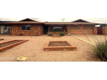 Charming brick home featuring desert landscaping and a well-maintained exterior at 4537 E Emelita Ave, Mesa, AZ 85206