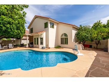 Backyard pool with concrete patio surrounded by mature trees at 2026 E Cortez Dr, Gilbert, AZ 85234