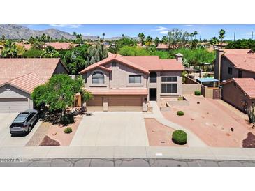 Beautiful two-story home featuring a spacious three-car garage and well-manicured desert landscaping at 3926 E Lavender Ln, Phoenix, AZ 85044