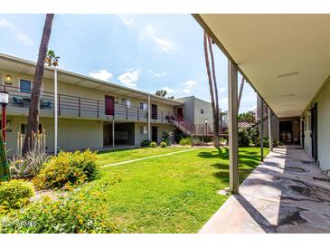 Charming apartment complex with lush green lawn and well-maintained landscaping at 4610 N 68Th St # 409, Scottsdale, AZ 85251