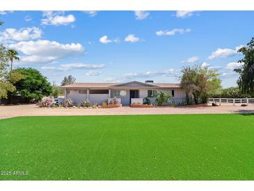 Charming single-story home with a well-maintained lawn and desert landscaping at 4613 E Shangri La Rd --, Phoenix, AZ 85028
