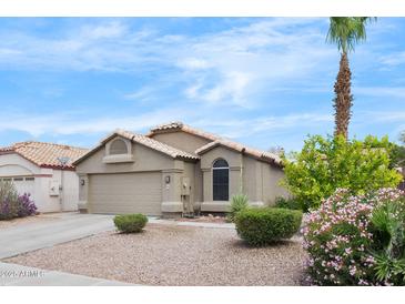 Charming single-story home featuring a two-car garage and desert landscaping at 8948 W Fargo Dr, Peoria, AZ 85382