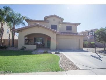 Charming two-story home featuring a welcoming front porch and a spacious two car garage with a basketball hoop at 13313 W Indianola Ave, Litchfield Park, AZ 85340