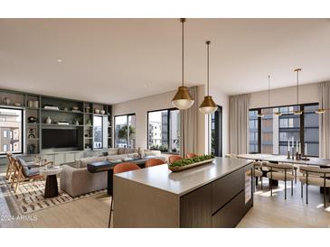 Bright, open-concept living space featuring modern kitchen island, dining area, and stylish built-ins at 19360 N 73Rd St # 1066, Scottsdale, AZ 85255