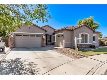 Charming single-Gathering home with a well-manicured lawn, three car garage, and neutral color palette at 19903 S 187Th Dr, Queen Creek, AZ 85142