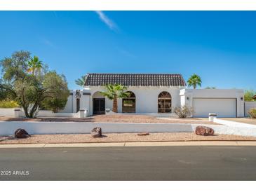 Beautiful home featuring a charming tiled roof, desert landscaping, and a private two-car garage at 3951 E Sequoia Trl, Phoenix, AZ 85044